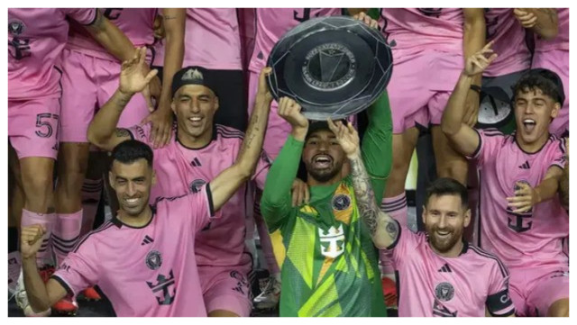 Inter Miami forward Lionel Messi (10) celebrates with his teammates Sergio Busquets(5), L uis Suårez (9) and Drake Callender (1) after winning the MlS Supporters' Shield
following their soccer match against the New England Revolution at Chase Stadium in